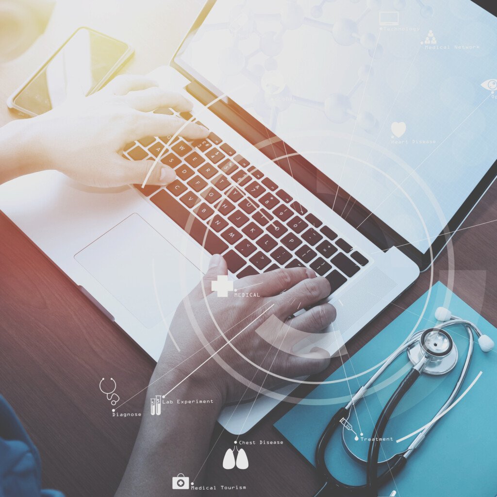 top view of smart medical doctor working with stethoscope and laptop and digital tablet computer on dark wooden desk with Vr diagram
